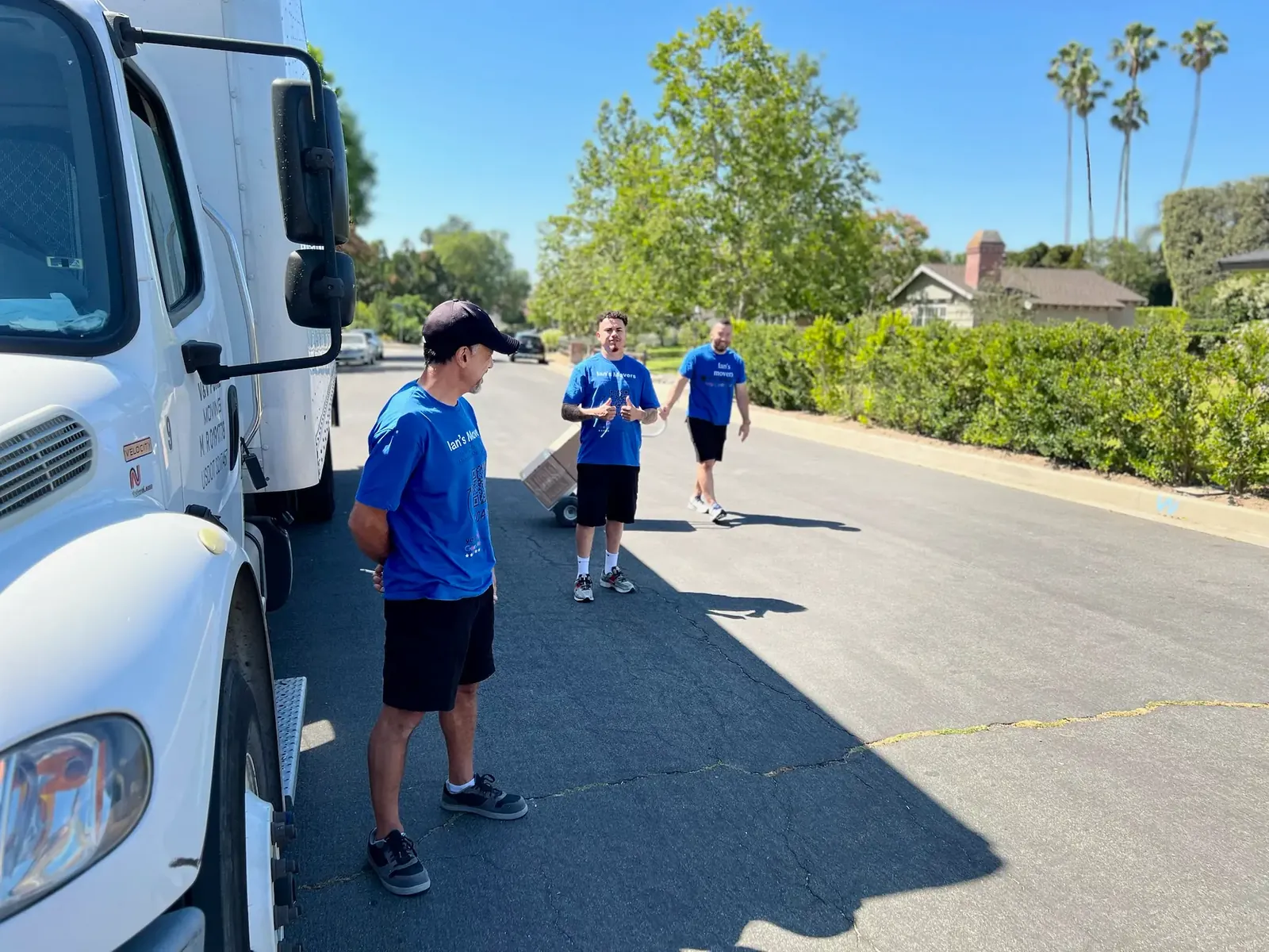 Ian's Movers crew beside a moving truck