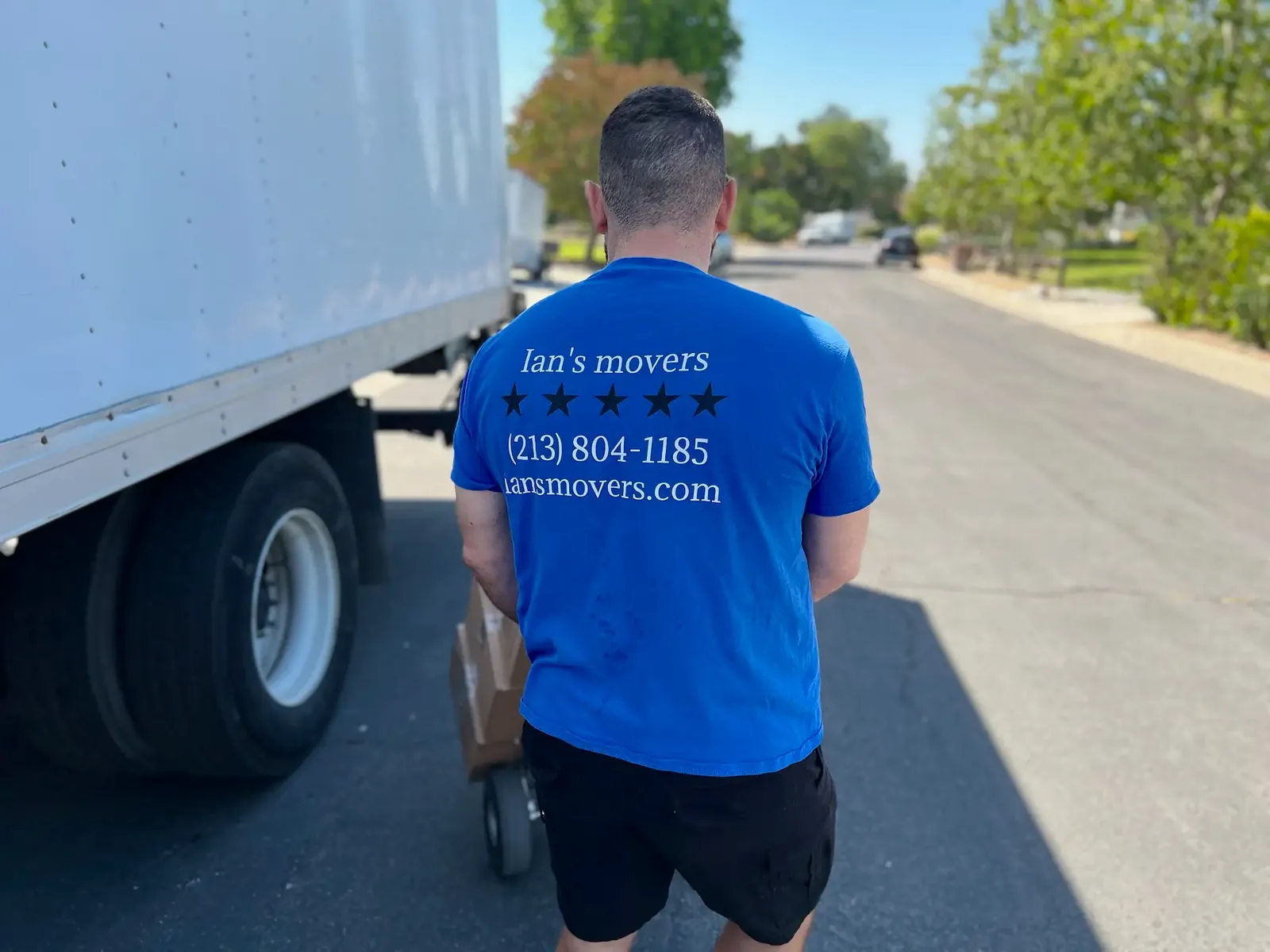 Ian's Movers mover working beside a moving truck
